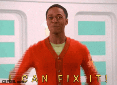 Man In Red Cardigan In Front Of I Can Fix It Sign GIF