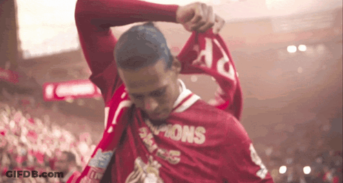 Man In Red Champions Shirt Holding Scarf GIF