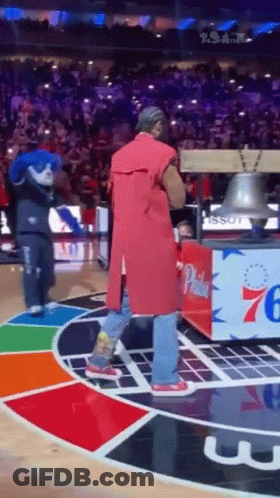 Man In Red Coat Holding Bell On Basketball Court GIF