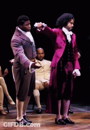 Man In Red Coat Holding Microphone GIF