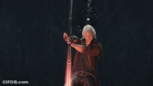 Man In Red Coat Holding Sword Surrounded By Fire GIF
