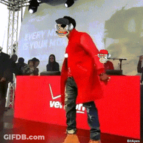 Man In Red Coat In Front Of Red Verizon Sign GIF