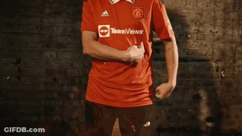 Man In Red Coat Running With Bucket On Back GIF