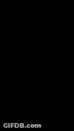 Man In Red Coat Walking Down Path GIF
