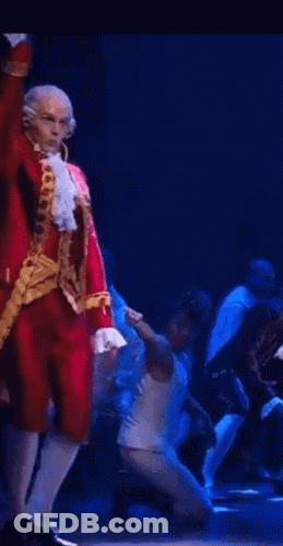 Man In Red Costume Dancing On Stage GIF