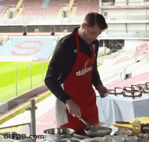 Man In Red Dafabet Apron Cooking GIF
