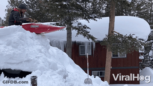 Man In Red Dagger Kayak Clearing Snow From House GIF