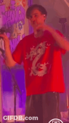 Man In Red Dragon Shirt Dancing On Stage GIF