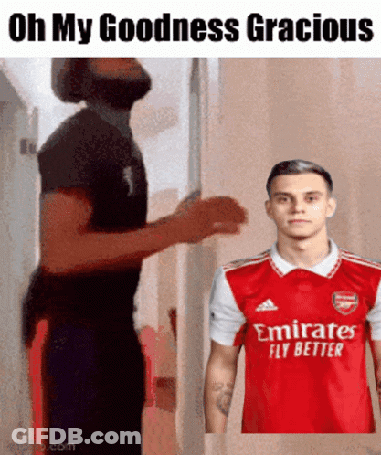 Man In Red Emirates Fly Better Shirt Next To Another Man GIF