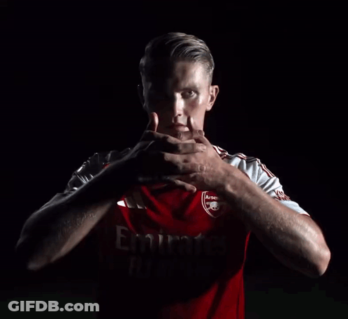Man In Red Emirates Jersey Holding Hands GIF