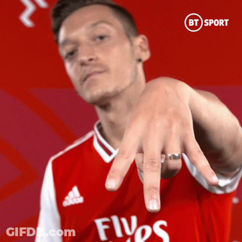 Man In Red Emirates Shirt Pointing GIF