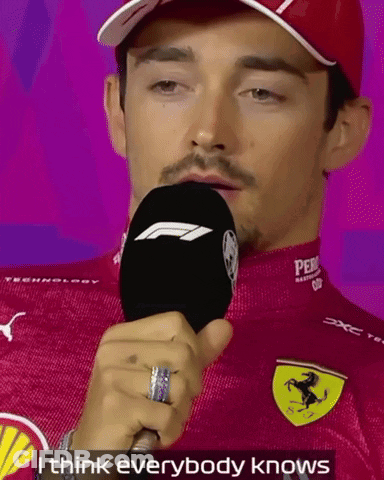 Man In Red Ferrari Shirt Holding Microphone GIF