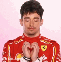 Man In Red Ferrari Suit Making Heart GIF