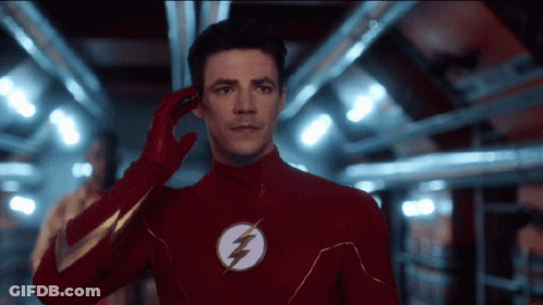 Man In Red Flash Suit Talking On Phone GIF