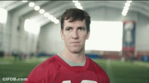 Man In Red Football Jersey Looking At Camera GIF