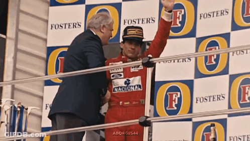 Man In Red Foster's Uniform On Stage GIF