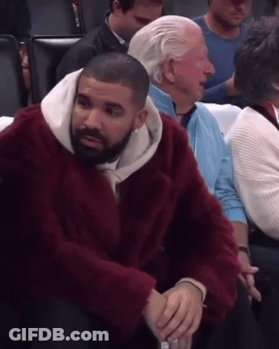 Man In Red Fur Coat Sitting In Stadium GIF