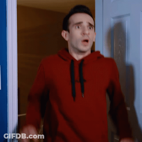 Man In Red Gap Hoodie Standing In Front Of Door GIF