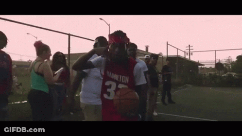Man In Red Hamilton Jersey Holding Basketball GIF