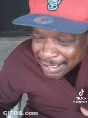 Man In Red Hat And Black Shirt Smiling GIF