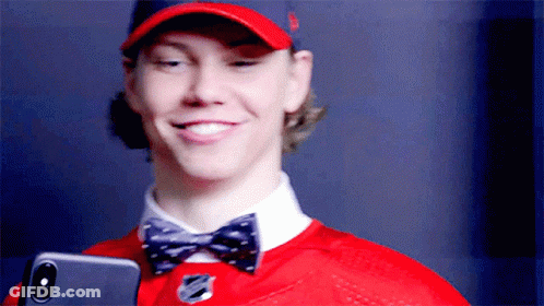 Man In Red Hat And Bow Tie Holding Phone GIF