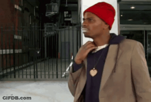 Man In Red Hat And Brown Jacket By Fence GIF