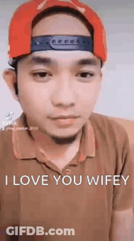 Man In Red Hat And Brown Shirt Making Funny Face GIF