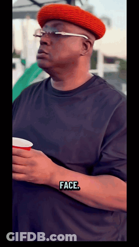 Man In Red Hat And Glasses Holding Cup Saying Face GIF