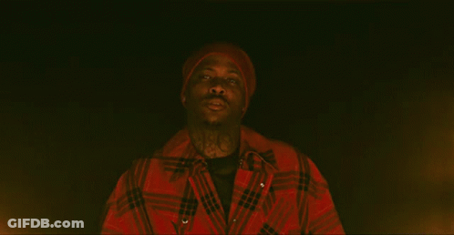 Man In Red Hat And Jacket Looking In Darkness GIF