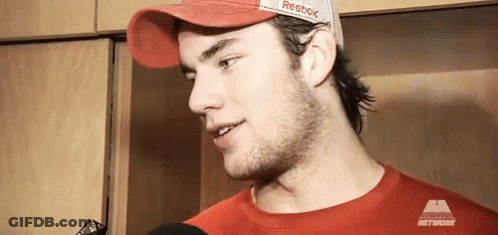 Man In Red Hat And Red T-Shirt Talking To Microphone GIF