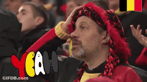 Man In Red Hat And Scarf Sitting In Crowd Saying Yeah GIF