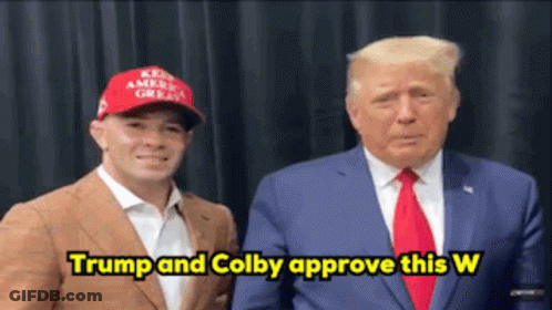 Man In Red Hat And Suit Saying Trump And Colby Approve This W GIF