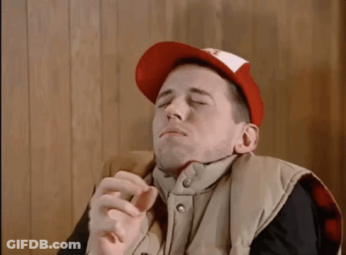 Man In Red Hat And Vest Smoking Cigarette GIF