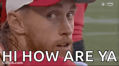 Man In Red Hat And White Hat Sitting On Football Field GIF