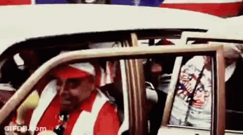 Man In Red Hat And White Vest Driving White Car GIF