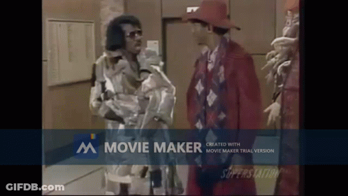 Man In Red Hat Beside Man In Red Suit GIF