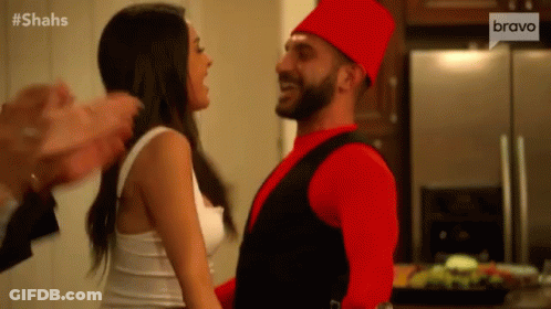 Man In Red Hat Dancing With Woman In White GIF