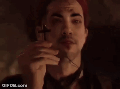 Man In Red Hat Holding Cross GIF