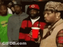 Man In Red Hat Holding Red Cup GIF