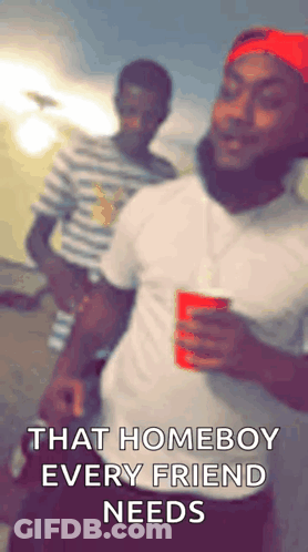 Man In Red Hat Holding Red Cup Next To Man In Striped Shirt GIF