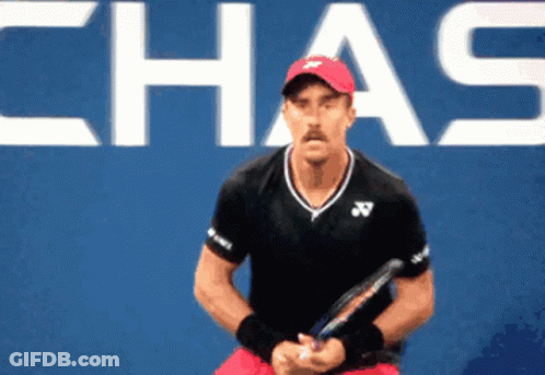 Man In Red Hat Holding Tennis Racquet Chas Sign GIF