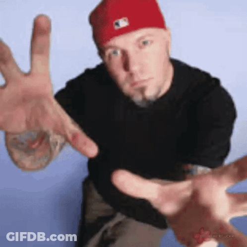 Man In Red Hat Hugging Woman Saying Wake Up It's Fred Durst Friday GIF