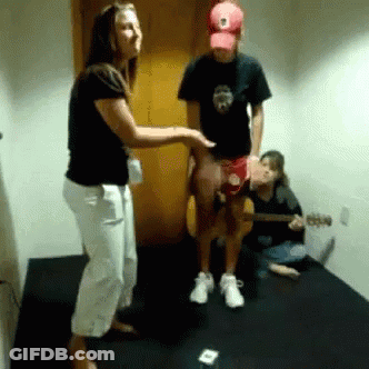 Man In Red Hat Playing Guitar Next To Woman GIF