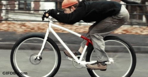 Man In Red Hat Riding Bike GIF