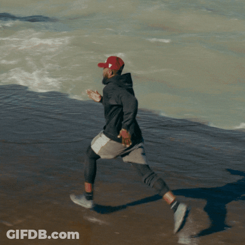 Man In Red Hat Running On Beach GIF