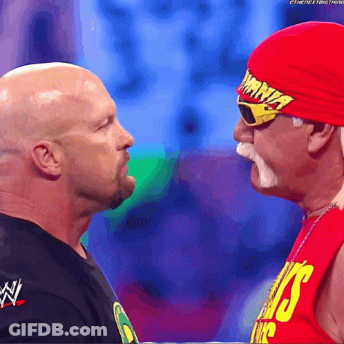 Man In Red Hat Saying Hulk Hogan Next To Another Man GIF