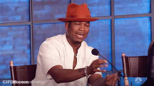 Man In Red Hat Sitting At Microphone GIF