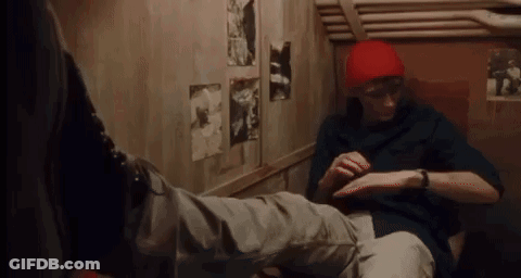 Man In Red Hat Sitting Next To Another Man GIF