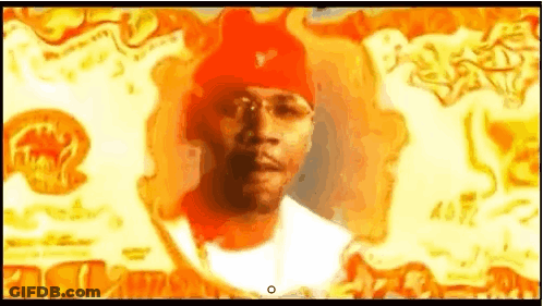 Man In Red Hat Standing In Front Of Fire GIF