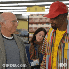 Man In Red Hat Talking To Another Man GIF